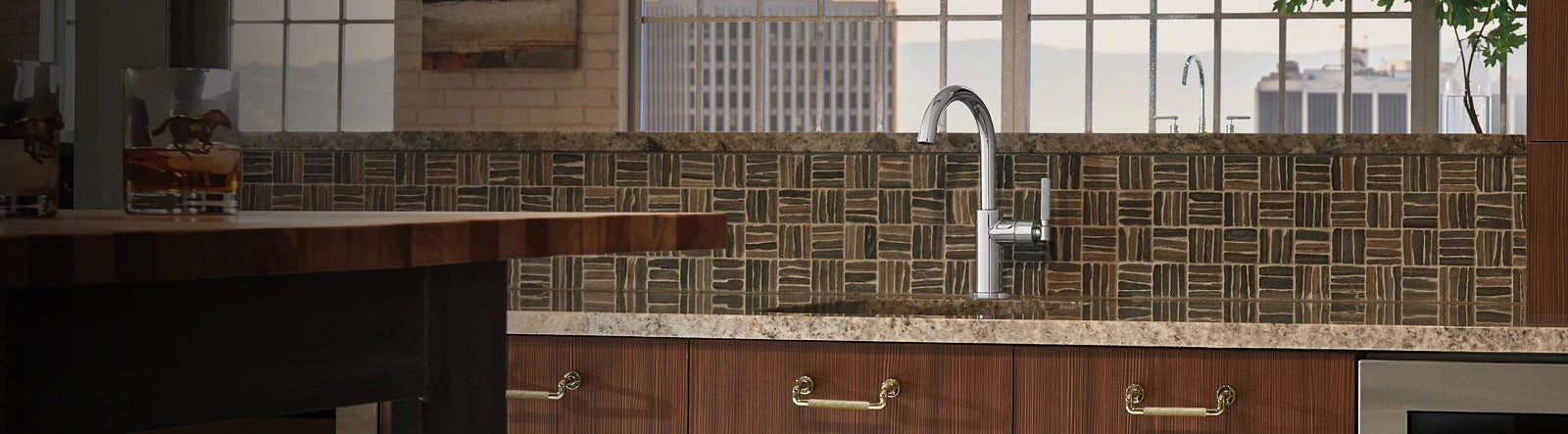 A bright kitchen featuring a sink, a counter, and a window, creating a welcoming and functional space.