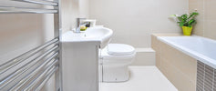 A clean bathroom featuring a sink, toilet, and bathtub, showcasing a modern and functional design.